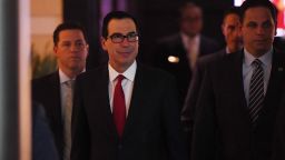 US Treasury Secretary Steven Mnuchin (C) walks through a hotel lobby as he heads to the US embassy in Beijing on May 3, 2018. - Top US and Chinese officials prepared on May 3 to kick off crucial trade talks in Beijing but both sides sought to dampen expectations for a quick resolution to a heated dispute between the world's two largest economies. (Photo by GREG BAKER / AFP)        (Photo credit should read GREG BAKER/AFP/Getty Images)