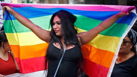 A woman holds the rainbow flag of the LGBT movement as she marches during ongoing celebrations of International Women's Day in Beirut on March 11.