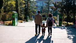 CHINA - 2016/10/23: A couple of young parents take their only kid's hand walking on the road.  China has one of the worlds lowest total fertility rates.  According to the 2016 China Statistical Yearbook, the countrys 2015 fertility rate was about 1.05  far below the 2.1 rate needed to keep the population level steady.  Chinese demography experts call on the central government to further loosen its birth control policy within two years owing to a predicted population decline in 2018. (Photo by Zhang Peng/LightRocket via Getty Images)