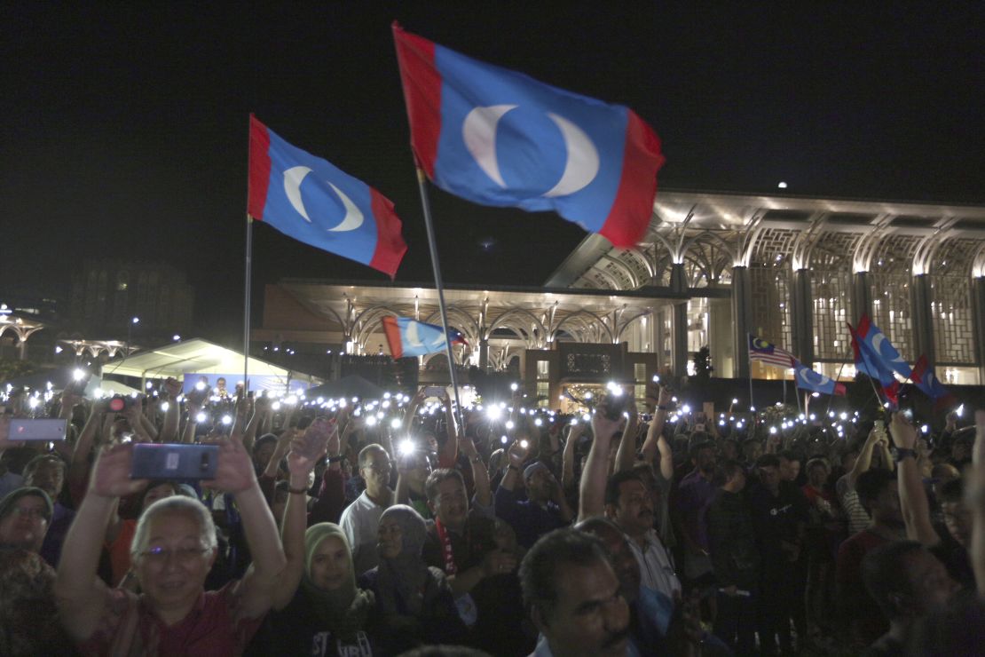 Supporters wave opposition party flags during an election campaign rally organized by Mahathir Mohamad, Putrajaya, Malaysia, May 3.