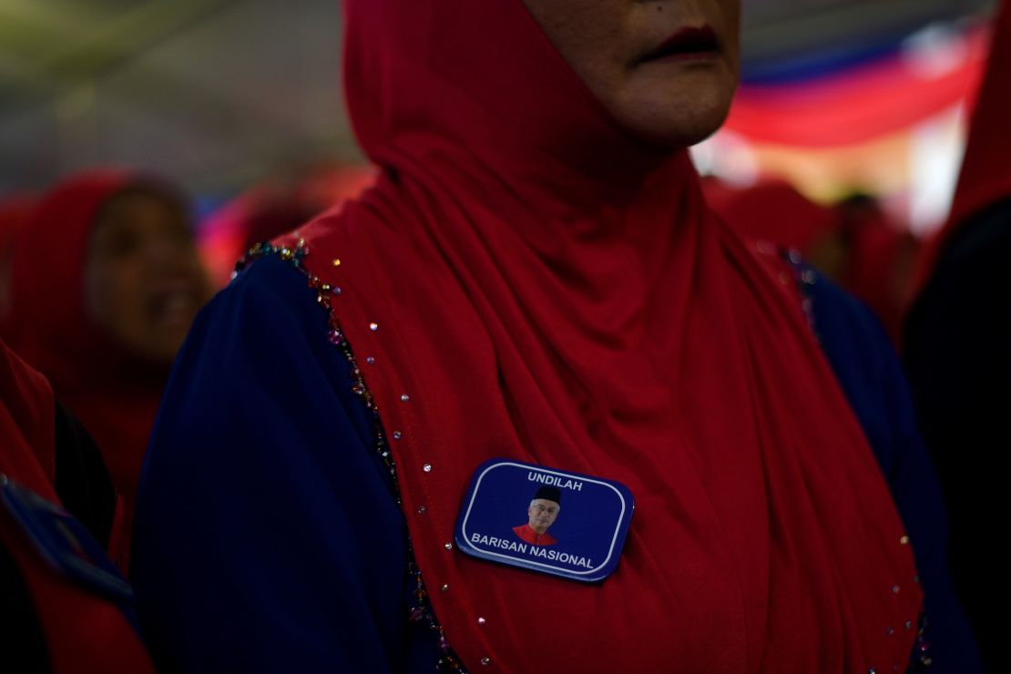 A supporter wears a lapel pin bearing a portrait of Malaysian Prime Minister Najib Razak, May 1, 2018.