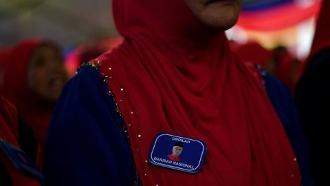 A supporter wears a lapel pin bearing a portrait of Malaysian Prime Minister Najib Razak, May 1, 2018.