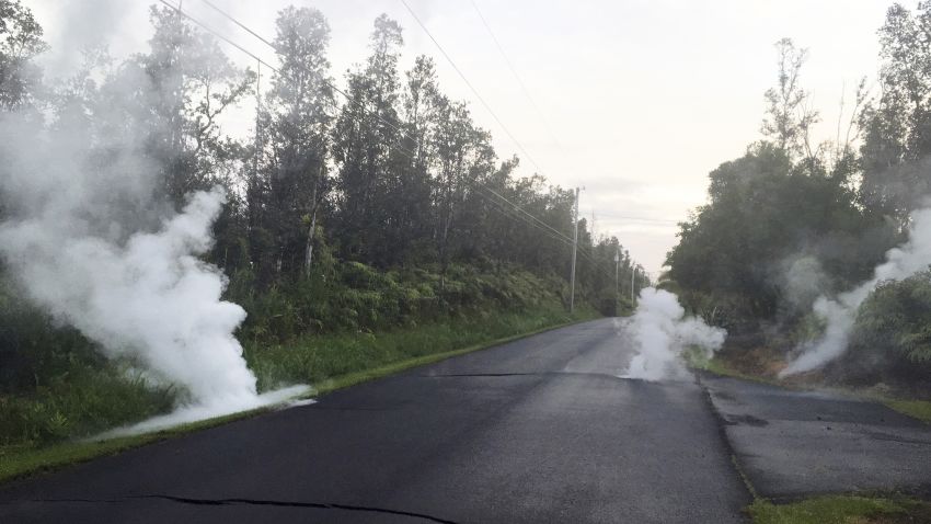 In this image released by the U.S. Geological Survey, steam rises from cracks in the road shortly before a fissure opened up on Kaupili Street in the Leilani Estates subdivision, Friday, May 4, 2018, in Pahoa, Hawaii. The Kilauea volcano sent more lava into Hawaii communities Friday, a day after forcing more than 1,500 people to flee from their mountainside homes, and authorities detected high levels of sulfur gas that could threaten the elderly and people with breathing problems.
 (U.S. Geological Survey via AP)