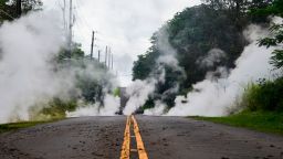 Steam rises from a fissure on a road in Leilani Estates subdivision on Hawaii's Big Island on May 4, 2018. - Up to 10,000 people have been asked to leave their homes on Hawaii's Big Island following the eruption of the Kilauea volcano that came after a series of recent earthquakes. (Photo by FREDERIC J. BROWN / AFP)        (Photo credit should read FREDERIC J. BROWN/AFP/Getty Images)