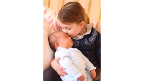 Princess Charlotte holds her new brother, Prince Louis, on May 2.