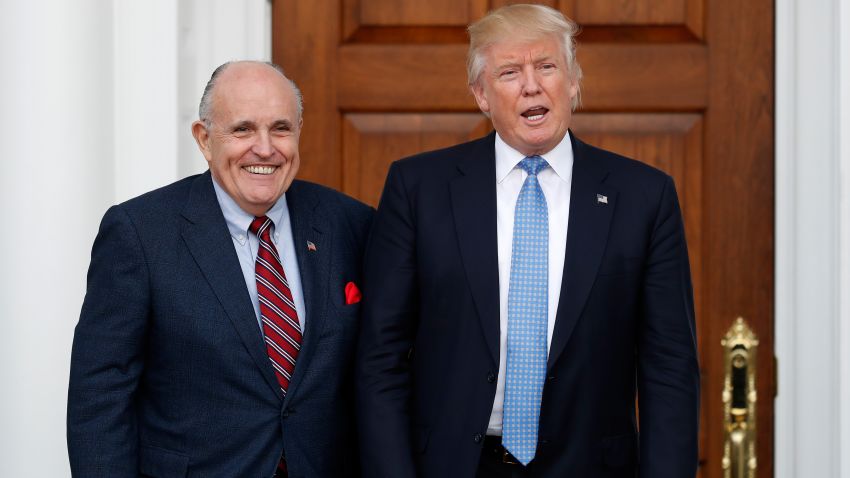 President-elect Donald Trump calls out to media as he and former New York Mayor Rudy Giuliani pose for photographs as Giuliani arrives at the Trump National Golf Club Bedminster clubhouse, Sunday, Nov. 20, 2016, in Bedminster, N.J.. (AP Photo/Carolyn Kaster)