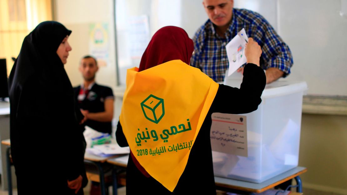 A Lebanese Hezbollah supporter casts a ballot at a polling station during the Lebanon's parliamentary elections in a southern suburb of Beirut.