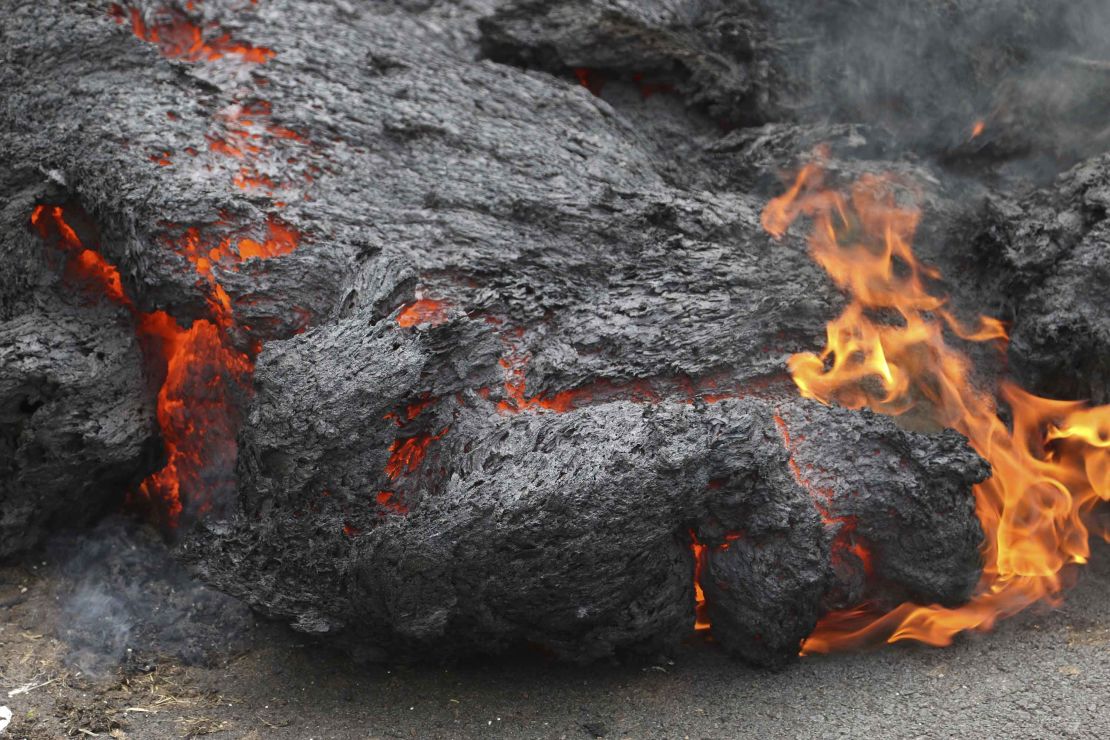 Lava burns across a road Saturday in the Leilani Estates community on Hawaii's Big Island.