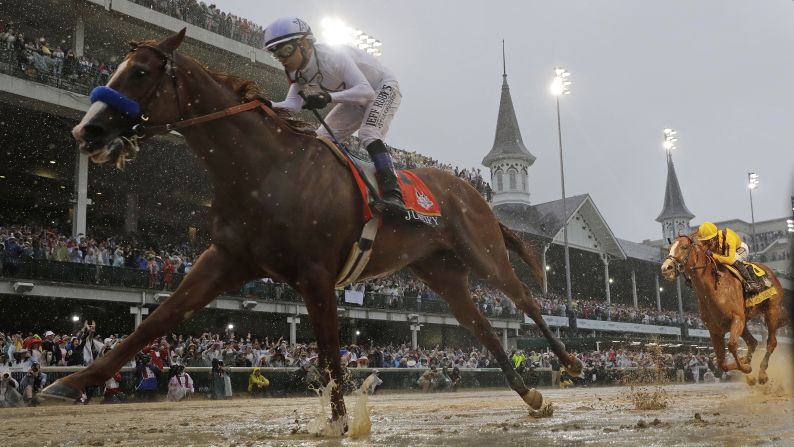 Mike Smith rides Justify to victory during the Kentucky Derby on Saturday, May 5. Justify was a 5-2 favorite in the race, which was <a href="index.php?page=&url=https%3A%2F%2Fwww.cnn.com%2F2018%2F05%2F05%2Fequestrian%2Fkentucky-derby-spt%2Findex.html" target="_blank">the wettest in the history of the event.</a> More than 3 inches of rain fell at Churchill Downs.