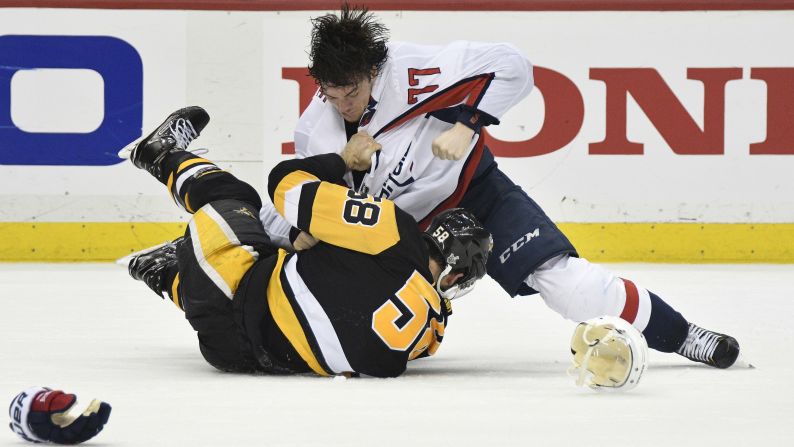 Washington forward T.J. Oshie, top, fights Pittsburgh defenseman Kris Letang during Game 4 of their second-round playoff series on Thursday, May 3.