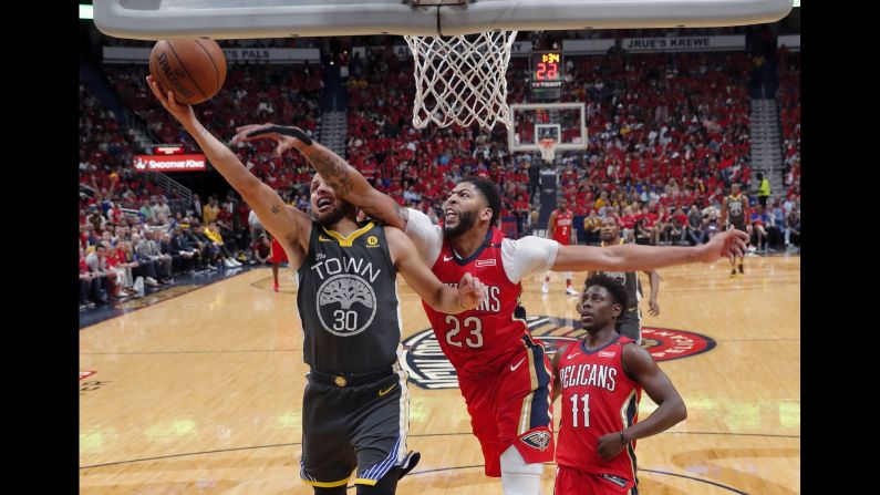 Golden State guard Stephen Curry tries to avoid New Orleans forward Anthony Davis during Game 3 of their NBA playoff series on Friday, May 4.