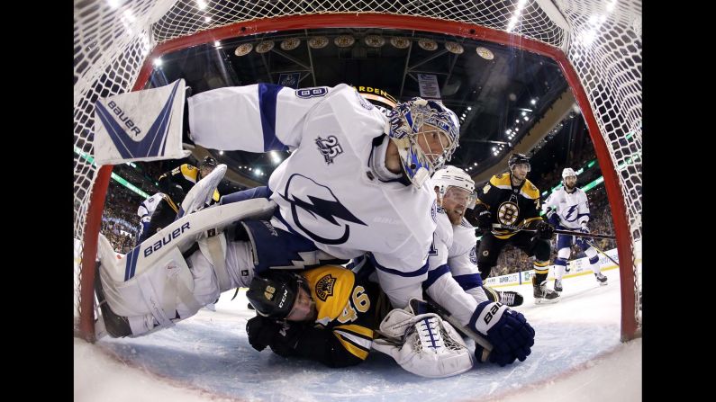 Tampa Bay goalie Andrei Vasilevskiy and forward Steven Stamkos lie on top of Boston's David Krejci during a goal-mouth scramble on Wednesday, May 2. Tampa Bay won the playoff series in five games to advance to the NHL's Eastern Conference Final.