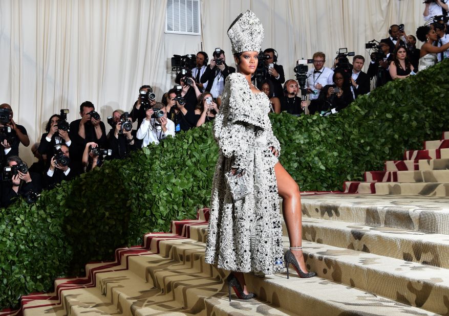 Rihanna dons a pope-inspired ensemble, including a jeweled miter. The singer co-chaired the event with Anna Wintour, Donatella Versace and Amal Clooney.<br />