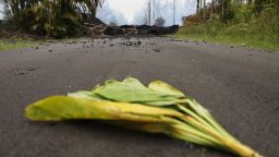 A ti leaf is left in the street near a lava flow on Monday as an offering to the Hawaiian volcano goddess Pele in the Leilani Estates neighborhood on Hawaii's Big Island