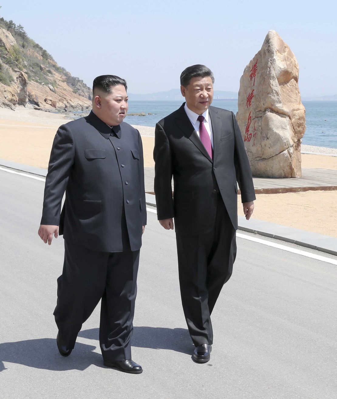 Xi and Kim during a stroll at their meeting in Dalian, China.