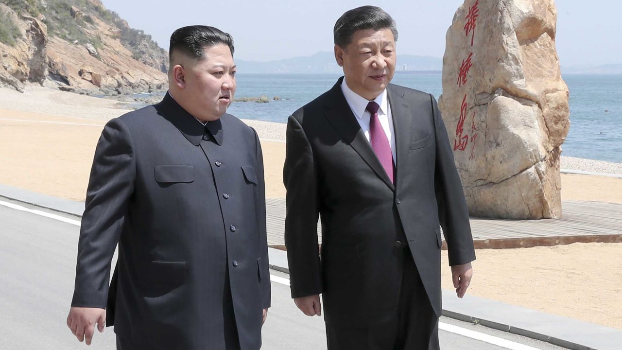 Xi and Kim during a stroll at their meeting in Dalian, China.