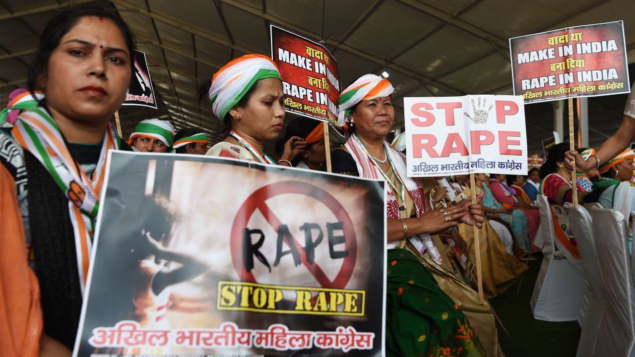 Supporters of President of the Indian National Congress Party Rahul Gandhi hold placards in reaction to the recent rape cases in India during a rally in New Delhi on April 29, 2018.