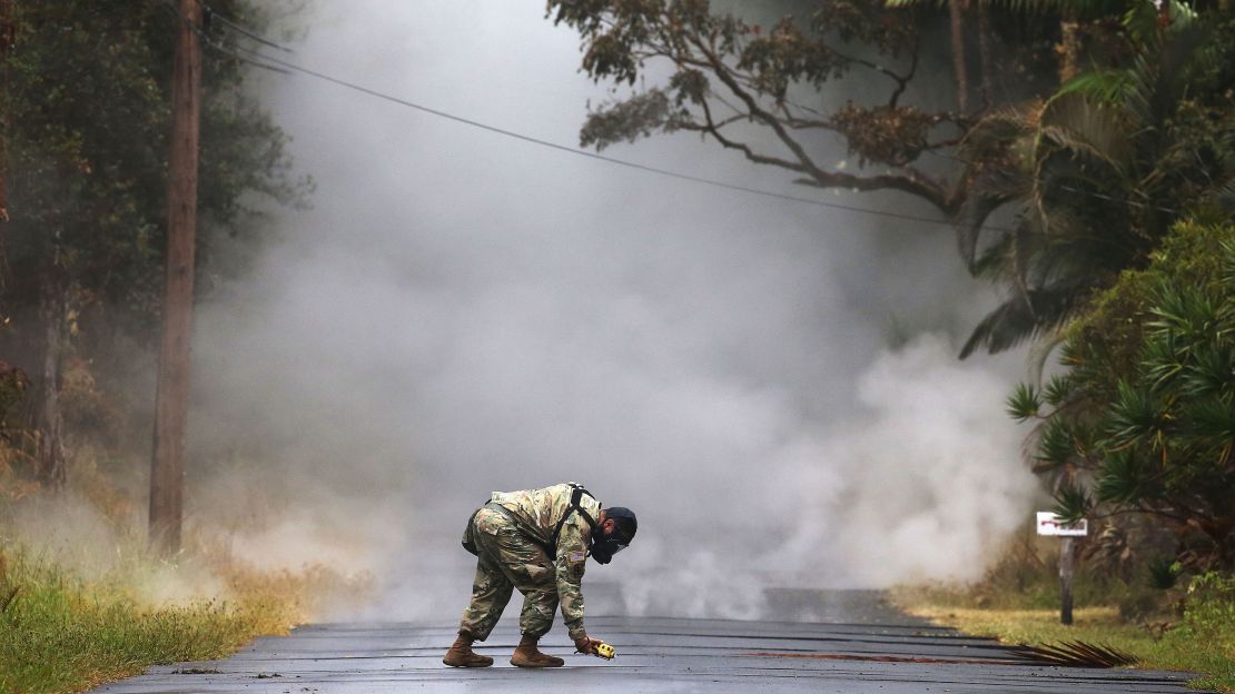 Army National Guard First Lt. Aaron Hew Len measures sulfur dioxide gas Tuesday in Leilani Estates.