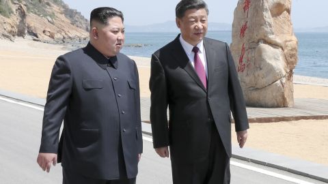 Chinese President Xi Jinping, right, walks with North Korean leader Kim Jong Un during a meeting in Dalian in northeastern China.