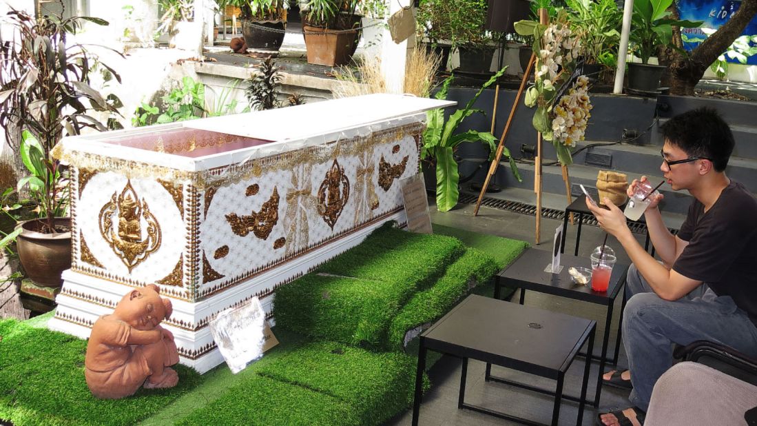 <strong>Cafe's centerpiece: </strong>Adorned on the outside with traditional gold-colored angelic spirits, the open white coffin awaits its next human.
