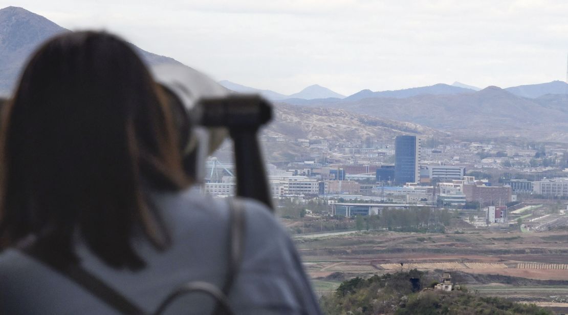 A tourist uses binoculars to look at the Kaesong Industrial Complex from an observatory on the south side of the demilitarized zone (DMZ). 