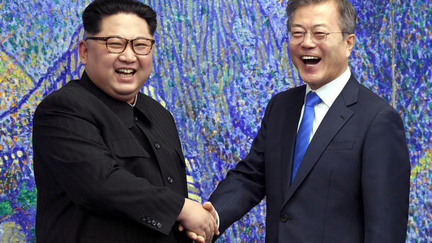 TOPSHOT - South Korea's President Moon Jae-in (R) shakes hands with North Korea's leader Kim Jong Un (L) during the Inter-Korean summit in the Peace House building on the southern side of the truce village of Panmunjom on April 27, 2018. - North Korean leader Kim Jong Un and the South's President Moon Jae-in sat down to a historic summit on April 27 after shaking hands over the Military Demarcation Line that divides their countries in a gesture laden with symbolism. (Photo by Korea Summit Press Pool / Korea Summit Press Pool / AFP)        (Photo credit should read KOREA SUMMIT PRESS POOL/AFP/Getty Images)