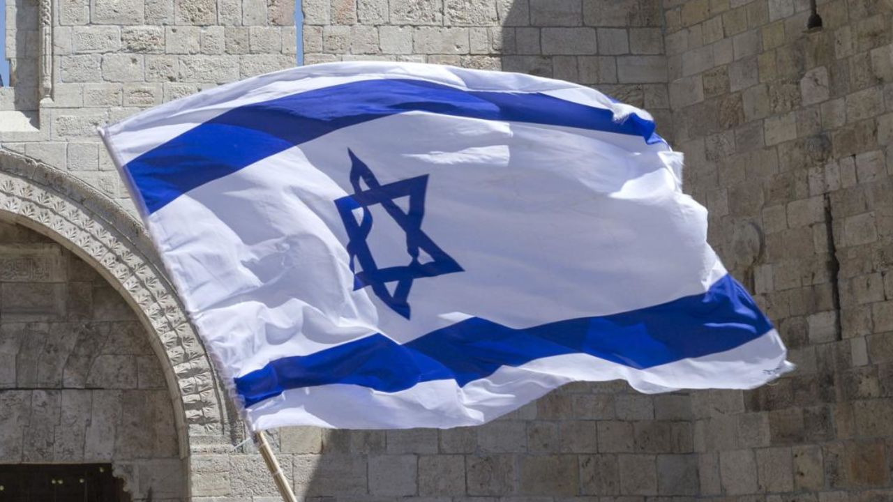 Israeli youths wave their national flag as they take part in the "flag march" through Damascus Gate in Jerusalem's old city during celebrations for Jerusalem Day on May 17, 2015 which marks the anniversary of the "reunification" of the holy city after Israel captured the Arab eastern sector from Jordan during the 1967 Six-Day War. AFP PHOTO / JACK GUEZ        (Photo credit should read JACK GUEZ/AFP/Getty Images)
