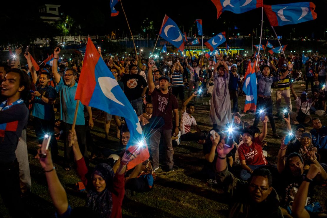 Supporters of Mahathir Mohamad, cheer as they watch live televised result announcement of the 14th general elections on May 10, 2018 in Kuala Lumpur, Malaysia.