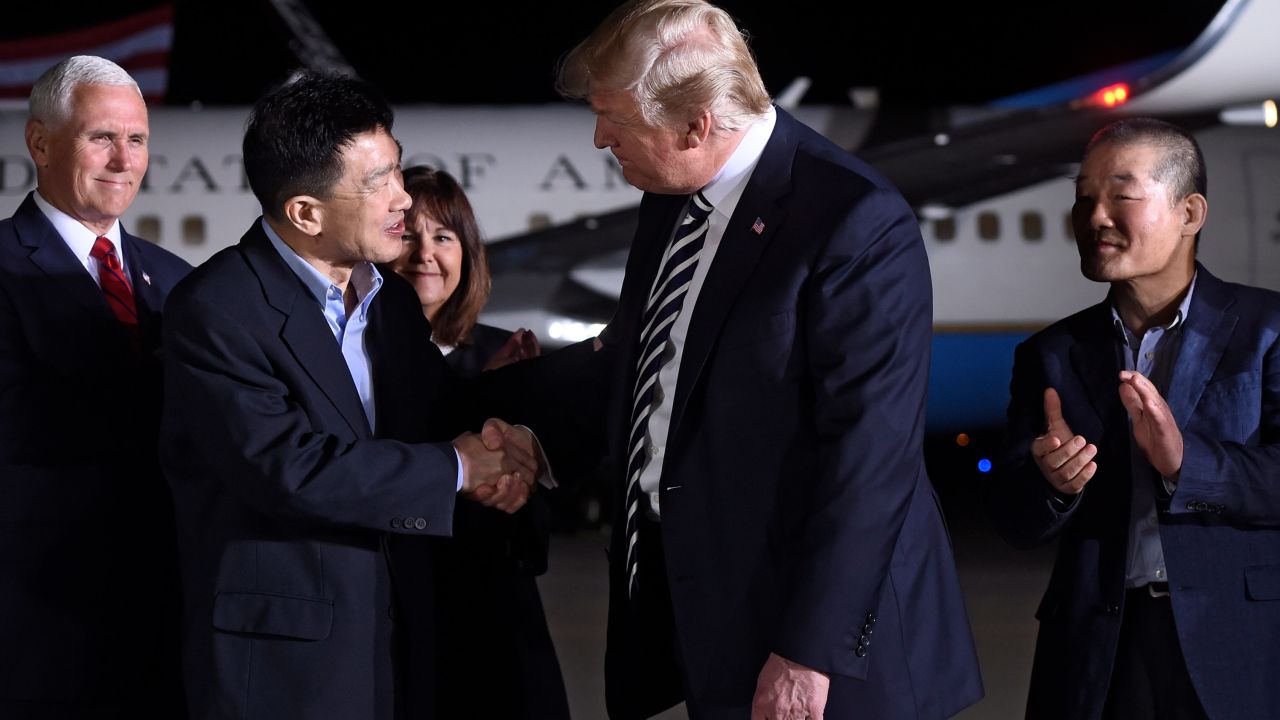 US President Donald Trump (2nd R) shakes hands with US detainee Tony Kim (2nd L) at Joint Base Andrews in Maryland on May 10.