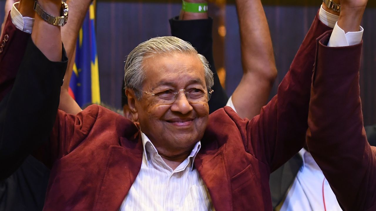 Mahathir Mohamad celebrates with his coalition leaders during a press conference in Kuala Lumpur on May 10.
