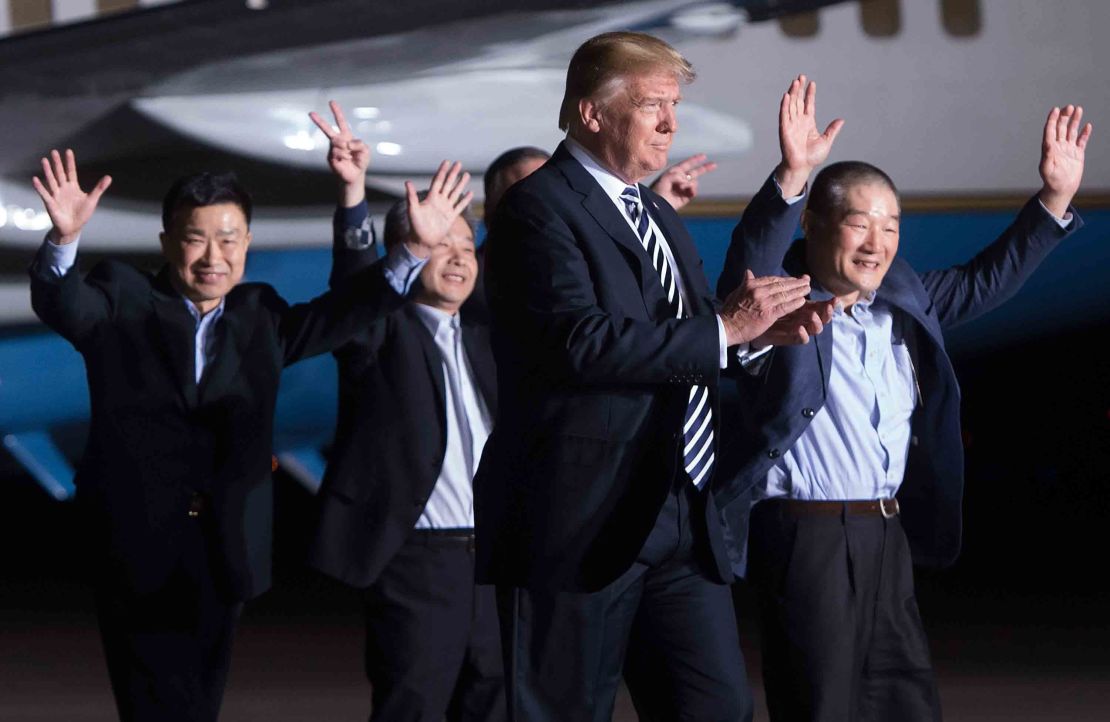 US President Donald Trump walks with the former US detainees on May 10, 2018, after their arrival at Joint Base Andrews in Maryland.