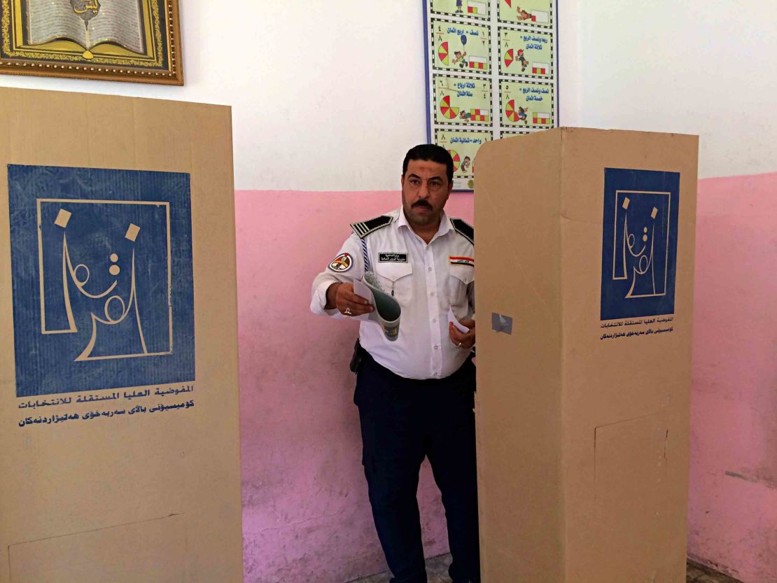 An Iraqi traffic policeman prepares to vote in Baghdad on May 10. Members of the security forces cast ballots before other voters.