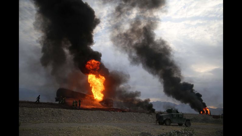 Firefighters work in Afghanistan's Nangarhar province after oil tankers were allegedly bombed by militants on Saturday, May 5.