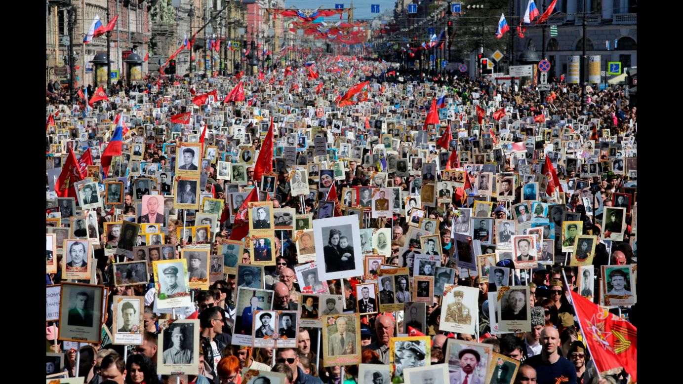 People in St. Petersburg, Russia, carry portraits of their ancestors, World War II veterans, during an "Immortal Regiment" march on Wednesday, May 9. The annual march pays tribute to those who helped defeat the Nazis 73 years ago.