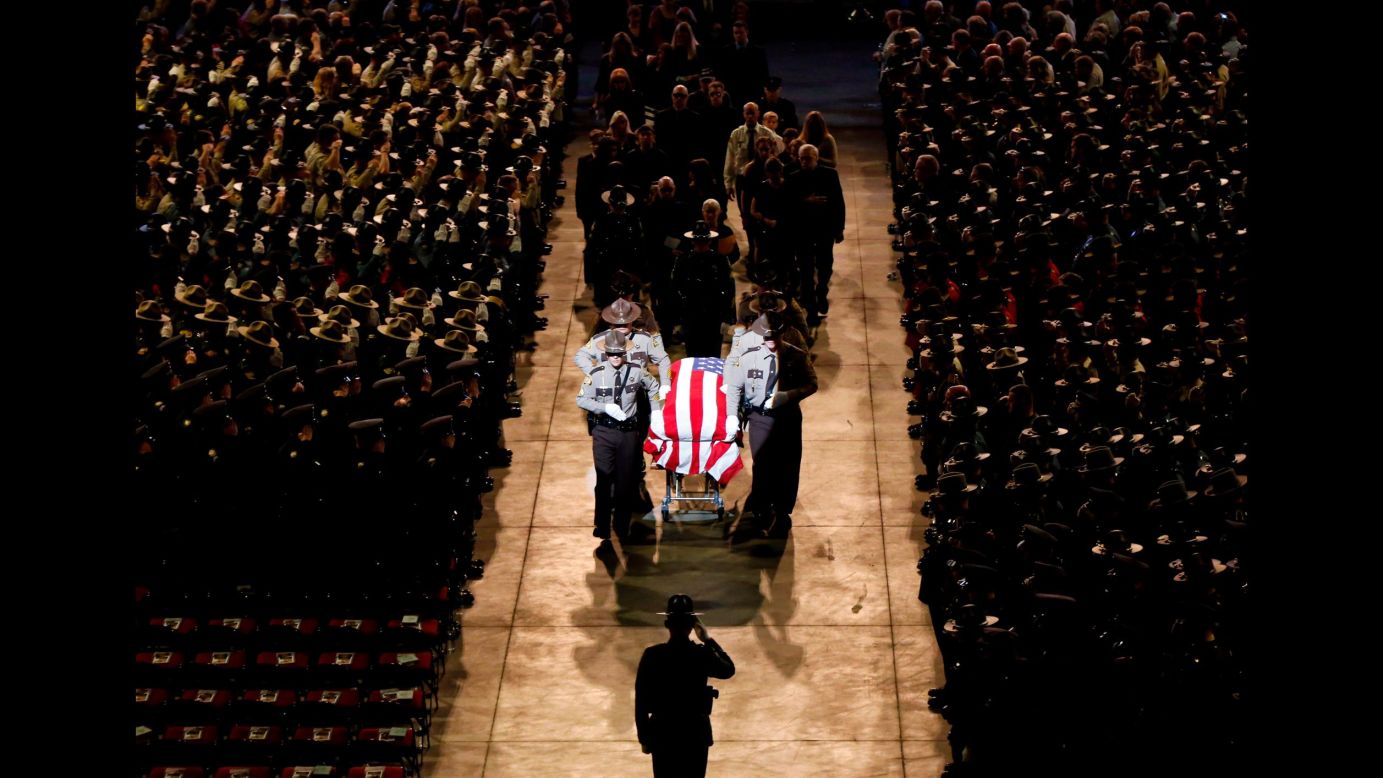 Pallbearers walk alongside the casket of Cpl. Eugene Cole at the conclusion of the sheriff's deputy funeral service in Bangor, Maine, on Monday, May 7. Cole, 61, <a href="https://www.cnn.com/2018/05/01/us/maine-police-officer-wife-facebook-post/index.html" target="_blank">was fatally shot last month</a> in the line of duty.