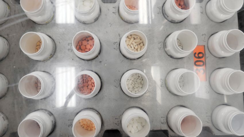 Bottles of prescription pills go through an automated packaging machine December 2, 2010 in the Medco pharmacy plant in Willingboro, New Jersey. 