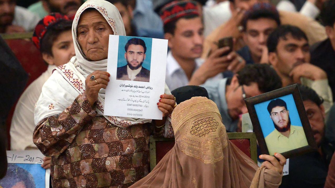 Pakistani demonstrators from the tribal Pashtun Protection Movement (PPM) hold pictures of missing family members during a rally in Peshawar. 