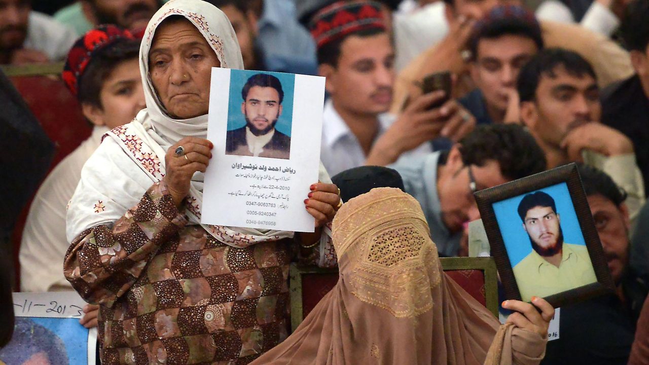 Pakistani demonstrators from the tribal Pashtun Protection Movement (PPM) hold pictures of missing family members during a rally in Peshawar.