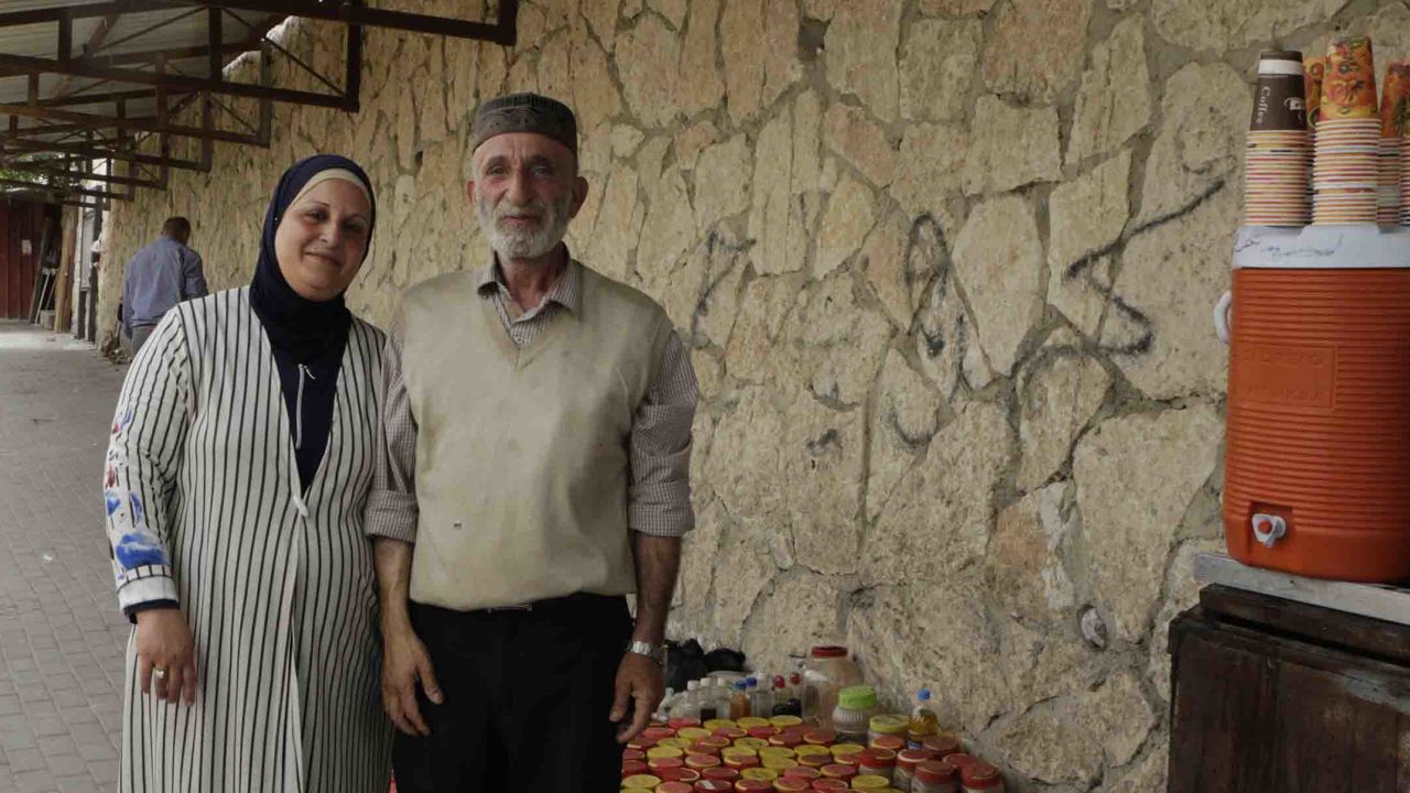 Abu Mohammad Al-Mashni and his wife, Um Mohammad Al-Mashni, both selling spices and coffee at Bethlehem checkpoint. 