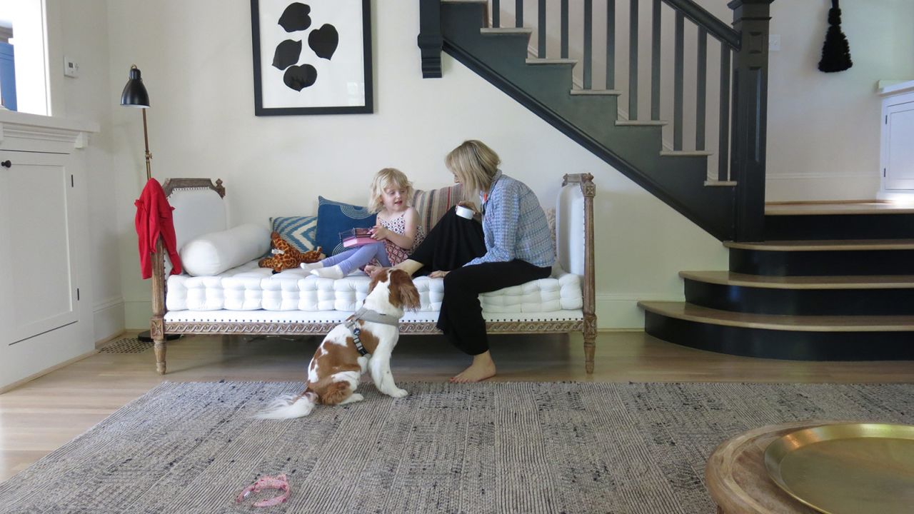 Erika Zak says her will to live is motivated by her daughter, Loïe. Here, they play on the couch as the family dog, Maddie, watches.