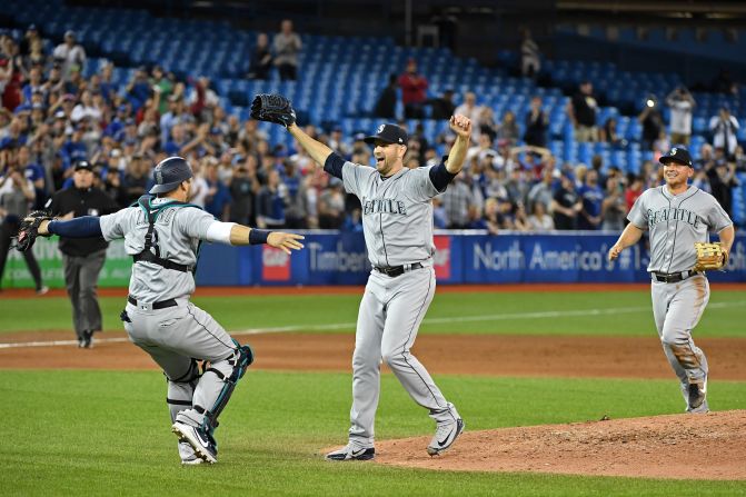 Seattle pitcher James Paxton, center, celebrates with his teammates after <a href="index.php?page=&url=https%3A%2F%2Fbleacherreport.com%2Farticles%2F2775066-mariners-james-paxton-strikes-out-7-en-route-to-no-hitter-vs-blue-jays" target="_blank" target="_blank">throwing a no-hitter</a> in Toronto on Tuesday, May 8. Paxton had seven strikeouts in the 5-0 victory.