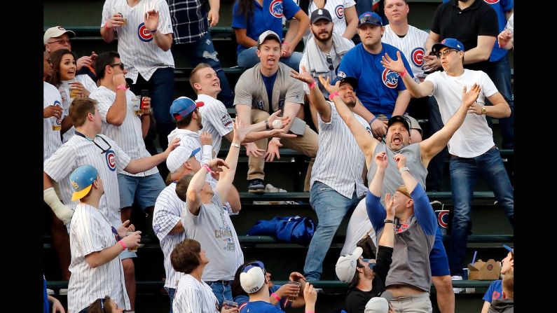 Fans at Chicago's Wrigley Field try to catch a home-run ball hit by Miami's Justin Bour on Tuesday, May 8.