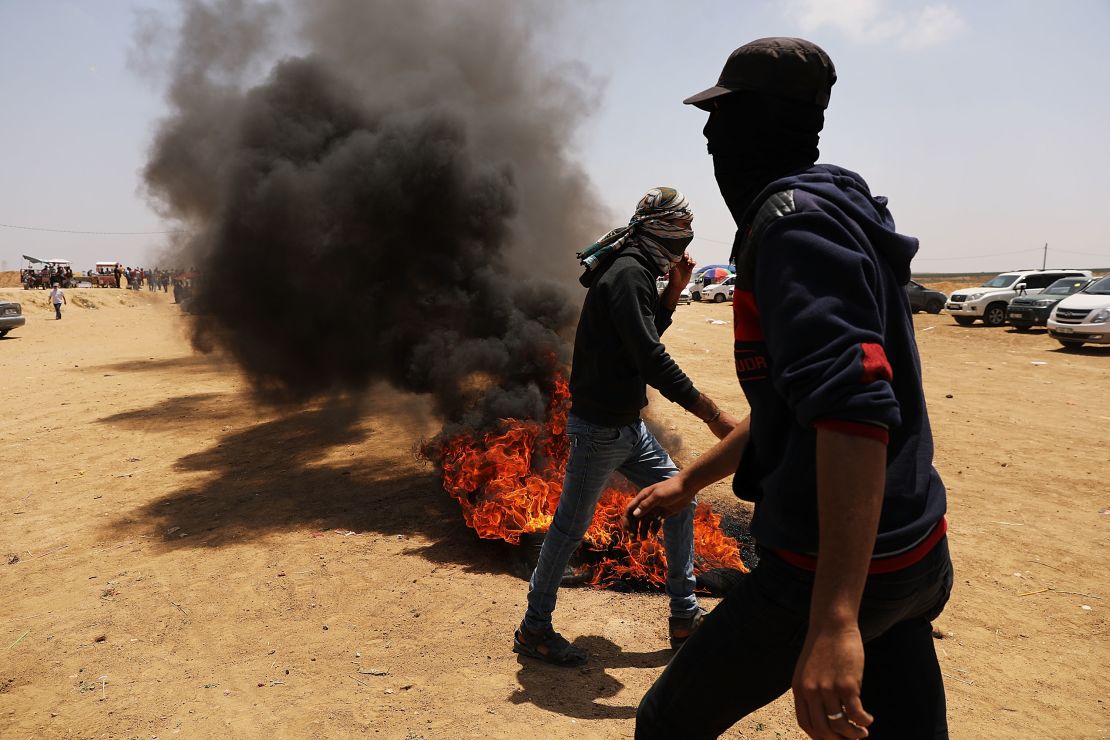 Palestinians burn tires near the border fence with Israel.