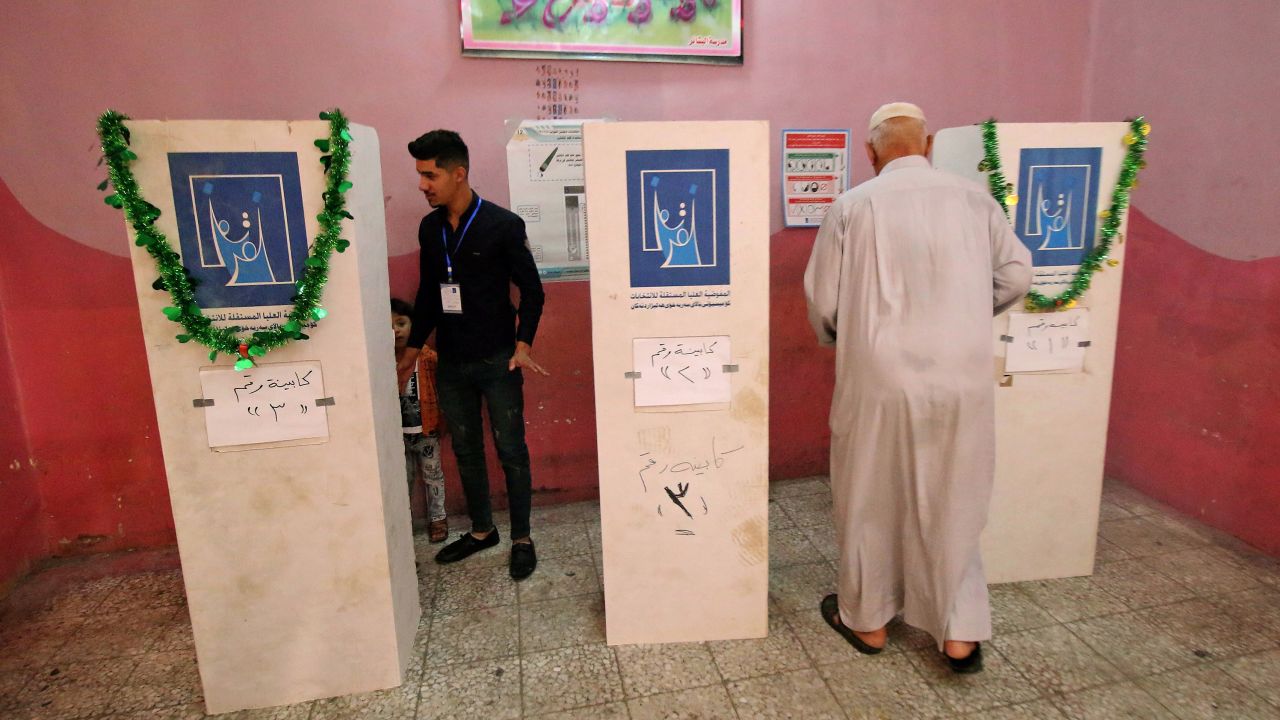 An Iraqi man walks toward a voting booth at a polling station in the southern city of Basra on May 12, 2018. 