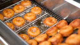 Deep frying doughnut machine close up