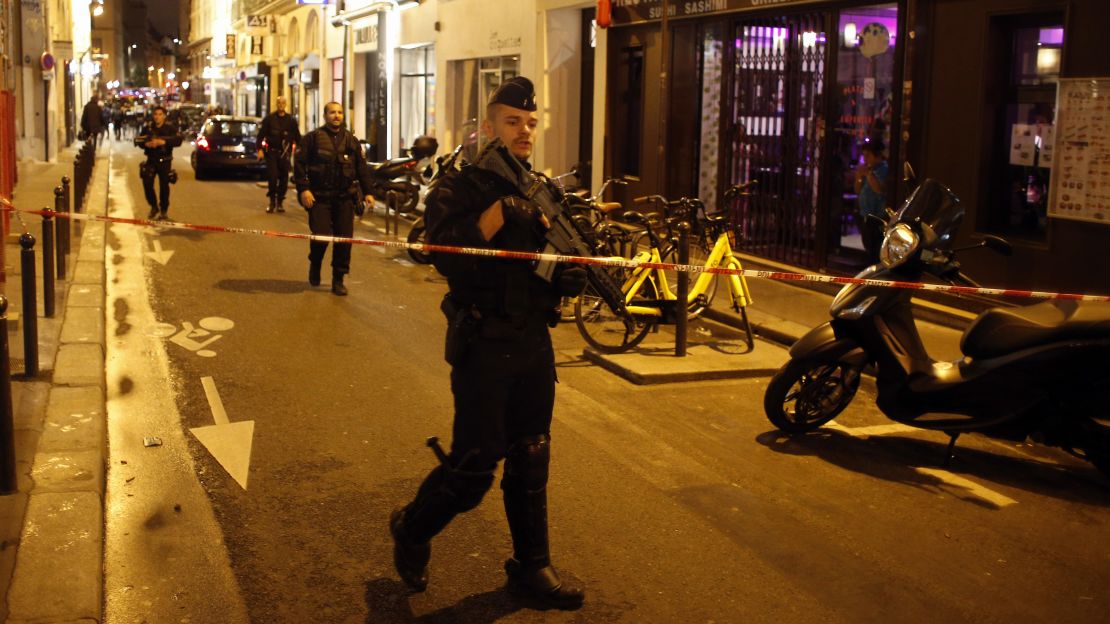 A police officer cordons off the area where the knife attack happened.