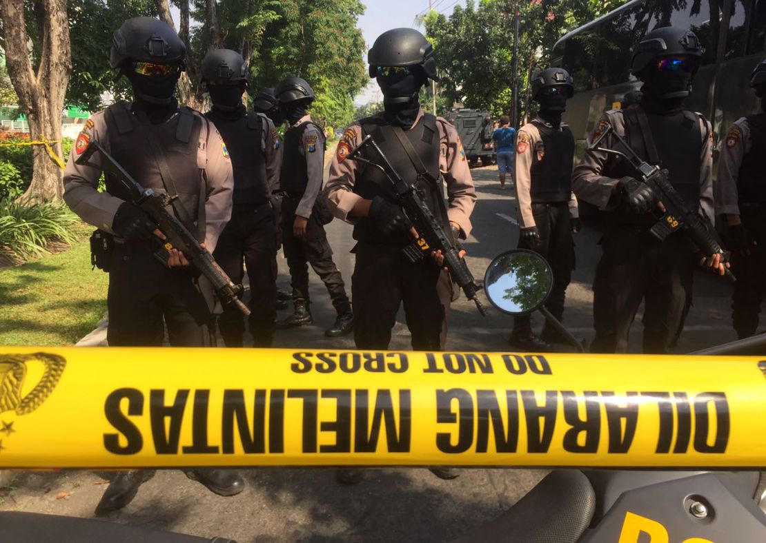 Police officers near the scene of hte blast at Santa Maria church in Surabaya, East Java, Indonesia.