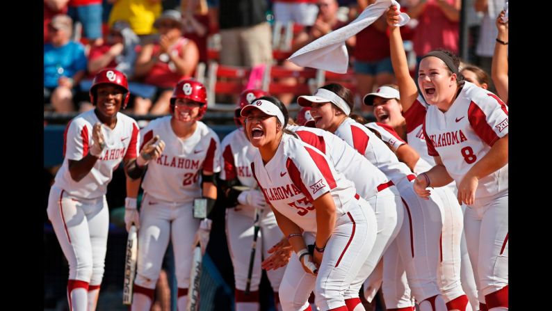 Oklahoma players celebrate at home plate as they wait for Nicole Pendley after a home run by Pendley against Baylor in the third inning during the championship game of the Big 12 softball tournament in Oklahoma City on Saturday, May 12.
