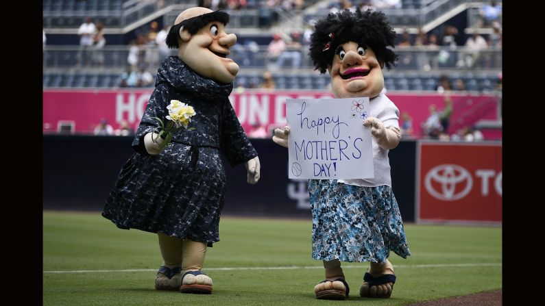 San Diego Padres mascot the Swinging Friar, left, walks on the field with another mascot dressed as the friar's mother to celebrate Mother's Day before a baseball game against the St. Louis Cardinals in San Diego on Sunday, May 13. 