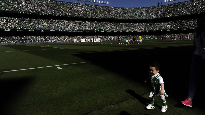 A child runs before the Spanish league football match between Real Betis and Sevilla at the Benito Villamarin stadium in Sevilla, Spain, on Saturday, May 12.